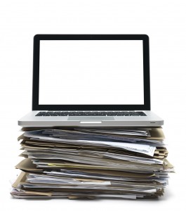 Laptop sitting on pile of files